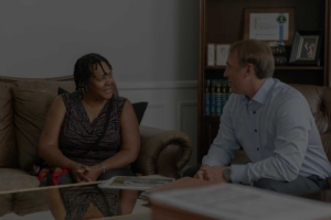 Mass torts lawyers consulting with a client about a case.